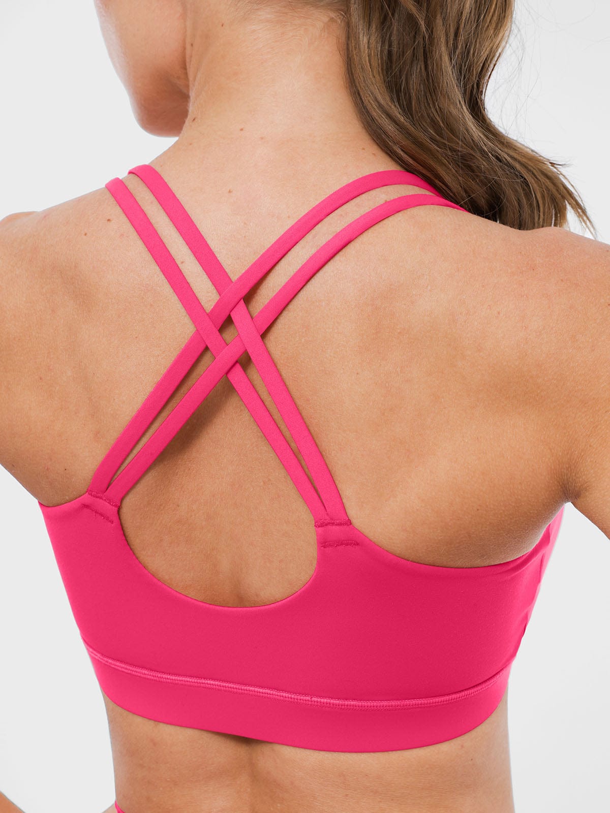 Side profile of Vractive strappy sports bra in Raspberry Red color