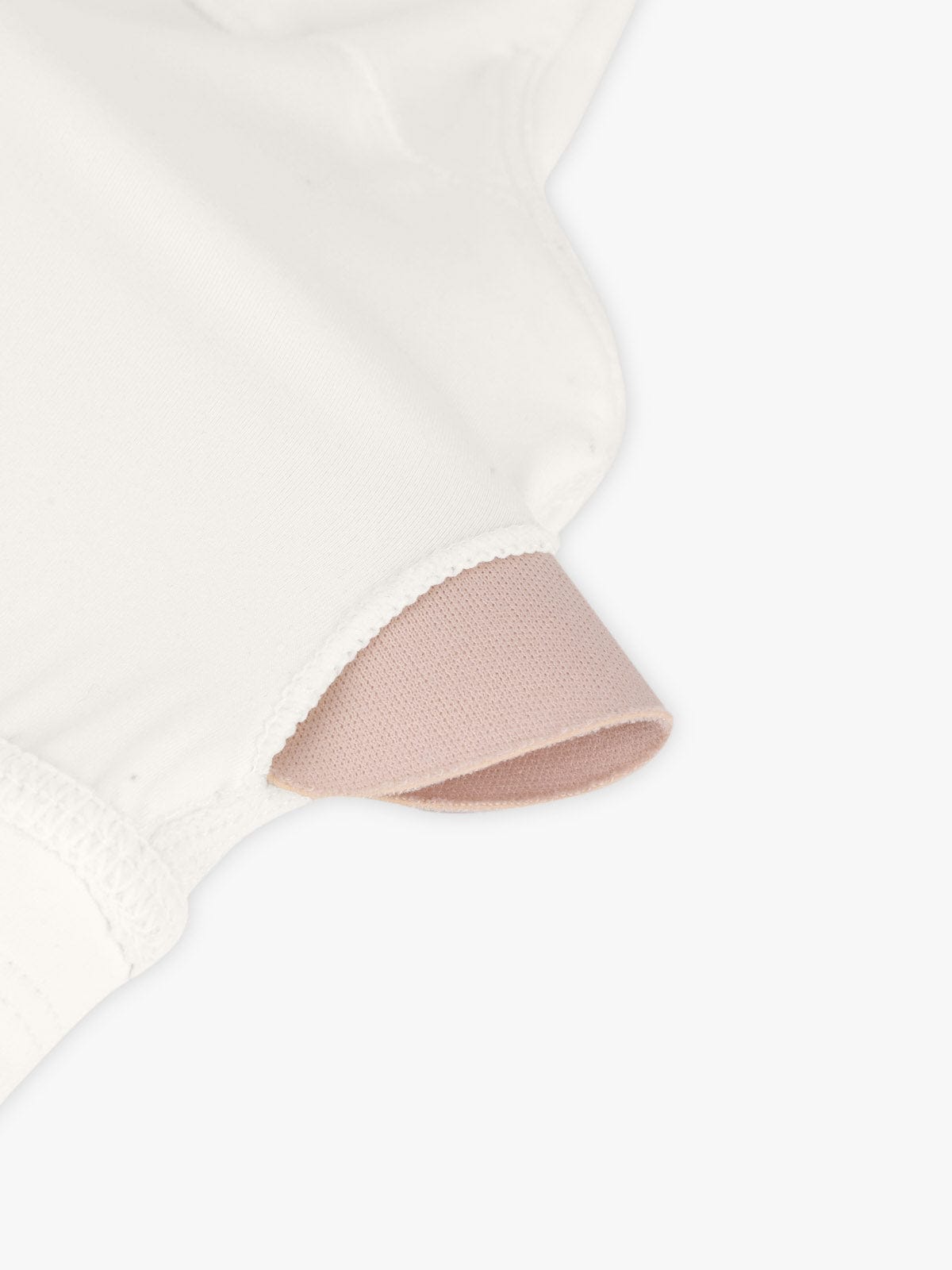Off White crisscross sports bra by Vractive displaying removable padding feature