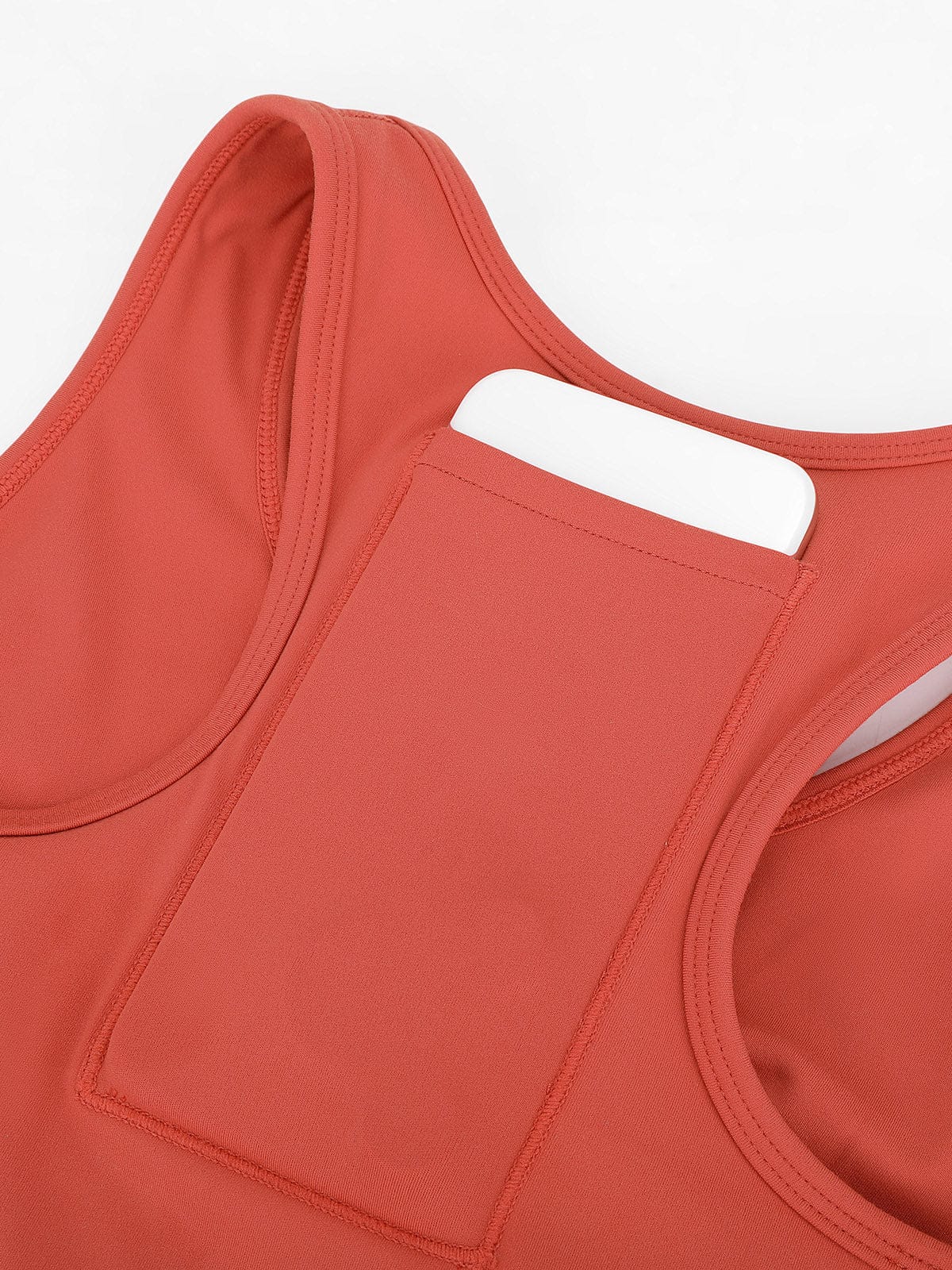 Macro view of secure back pocket for keys or cards on Mineral Red Vractive sports bra