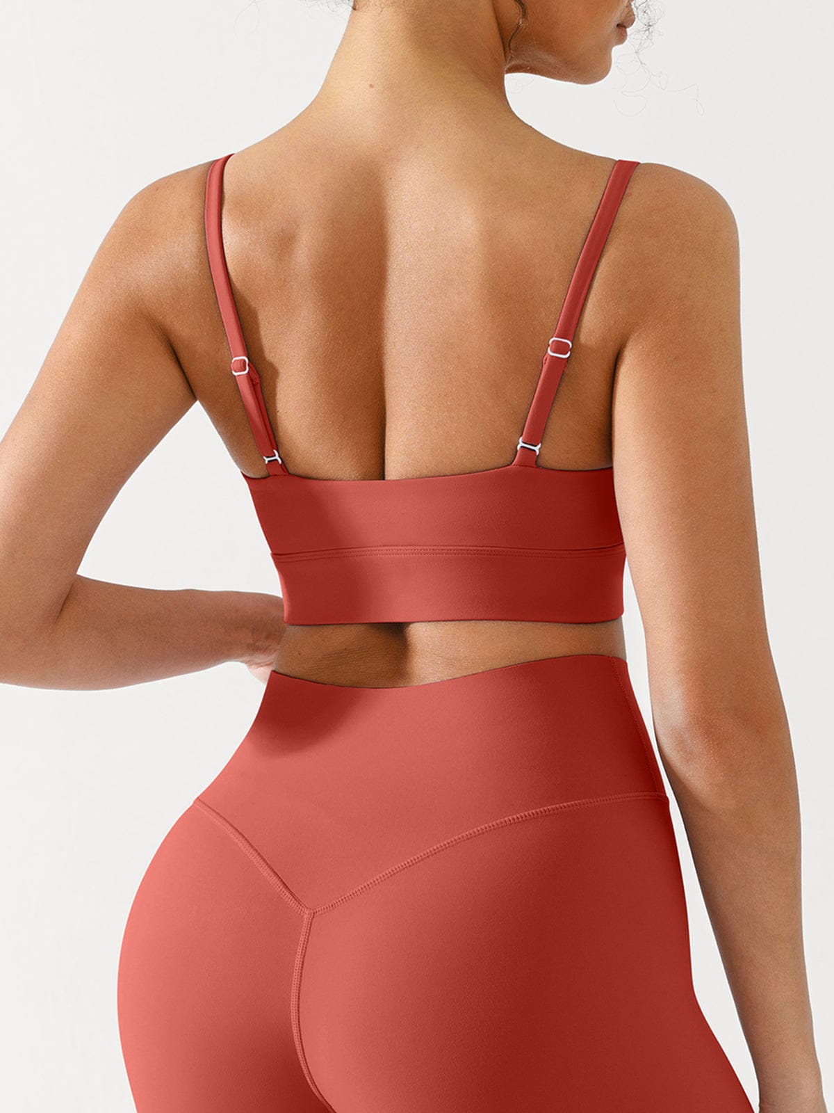 Mineral Red sports bra by Vractive showing adjustable straps for custom support