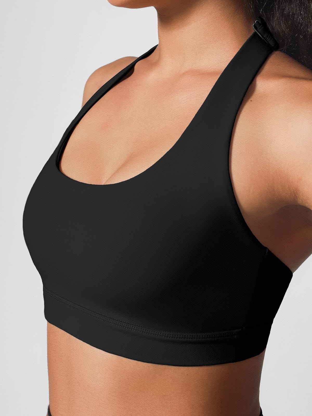 Model wearing Vractive Standard Black halter neck activewear side view