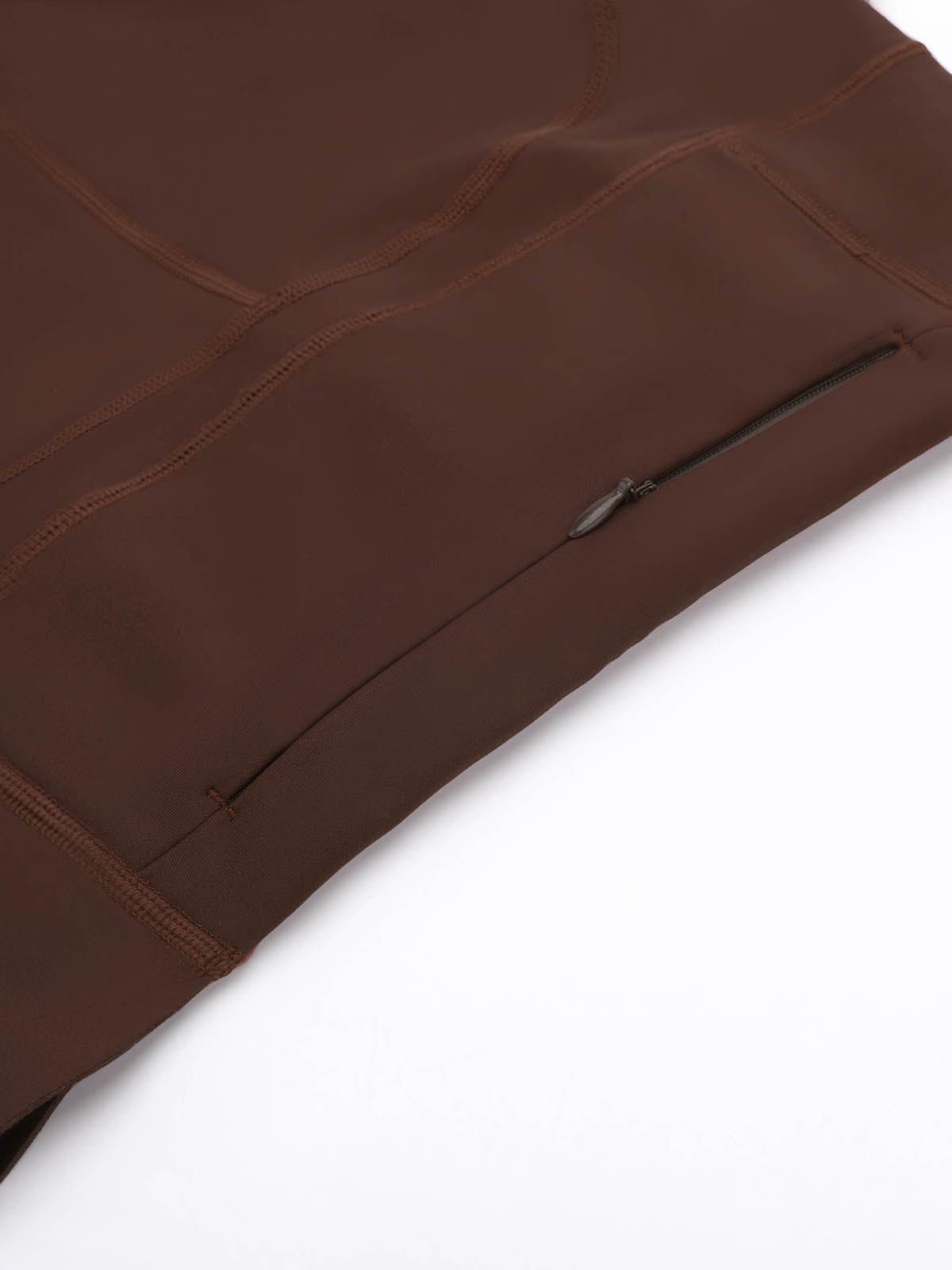 Macro detail of the convenient zipper pocket on Chocolate Brown Vractive yoga leggings