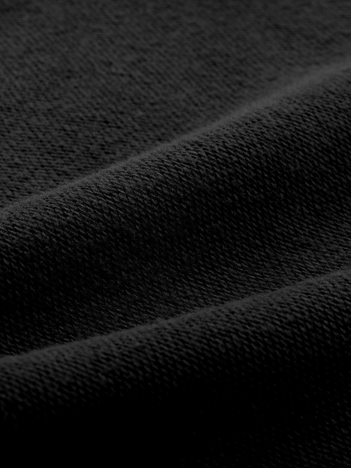 Detail shot of the opaque, durable Black lounge fabric on Vractive wide leg athleisure pants