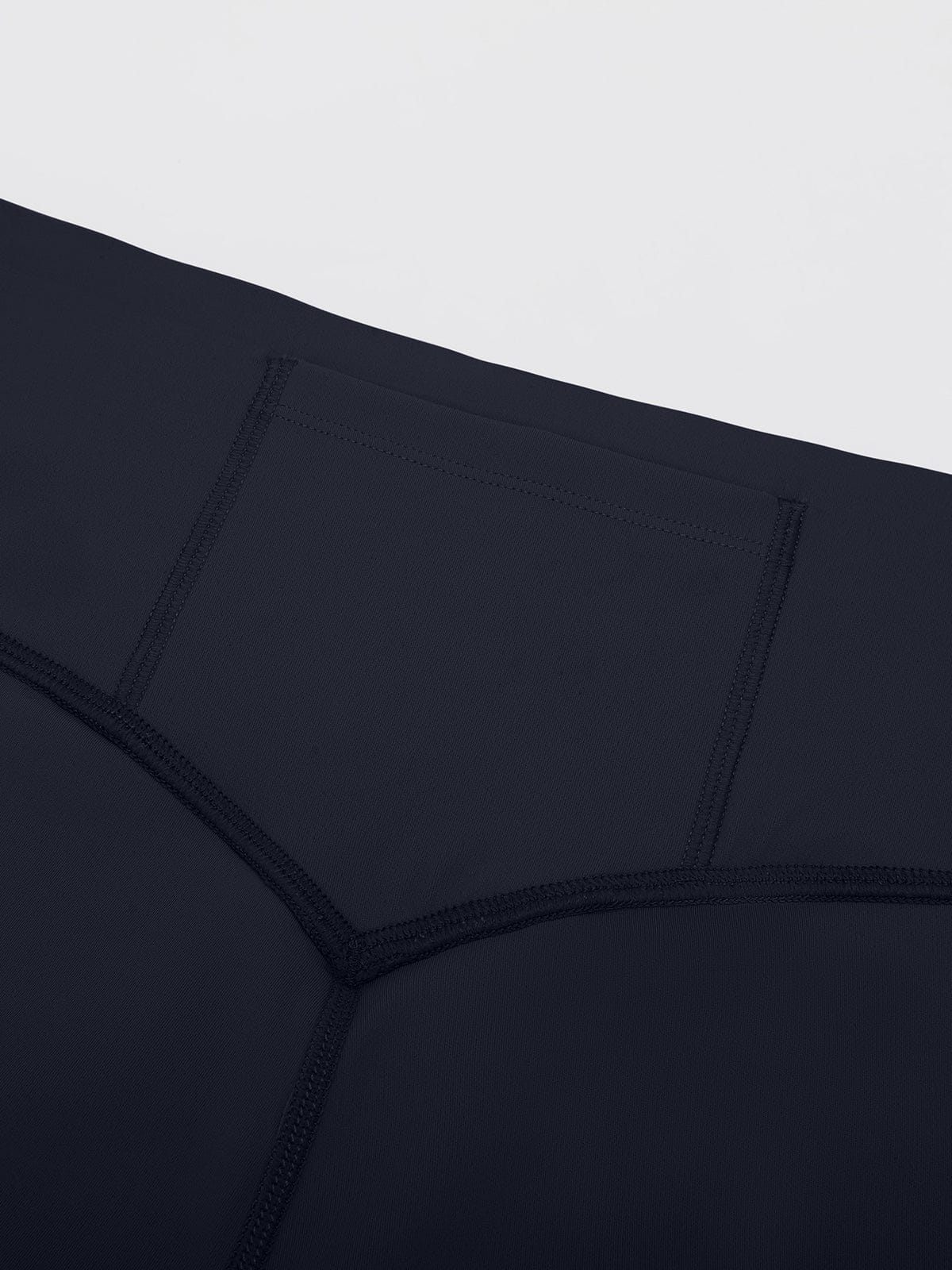 Close-up of the secure and smooth waistband stitching on Navy Blue Vractive mid rise bootcut leggings