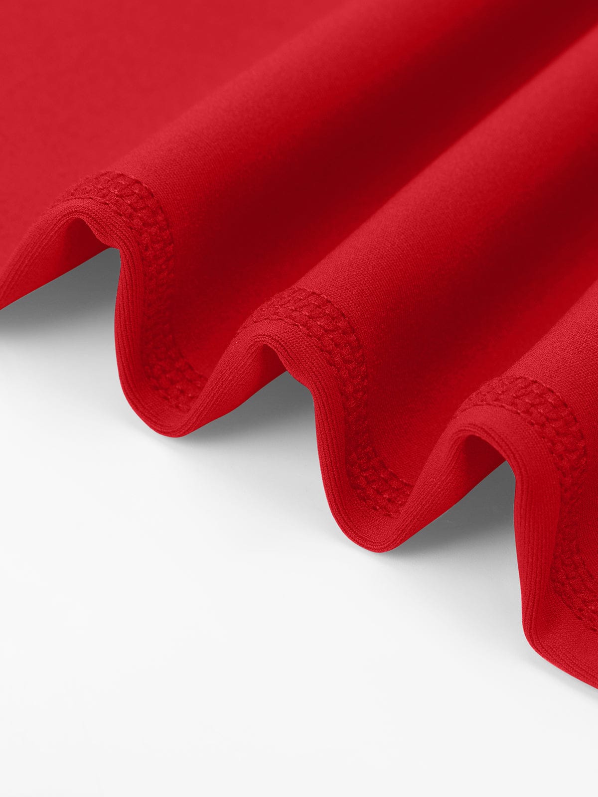 Close-up of the reinforced stretch stitching on Chili Red Vractive gym leggings