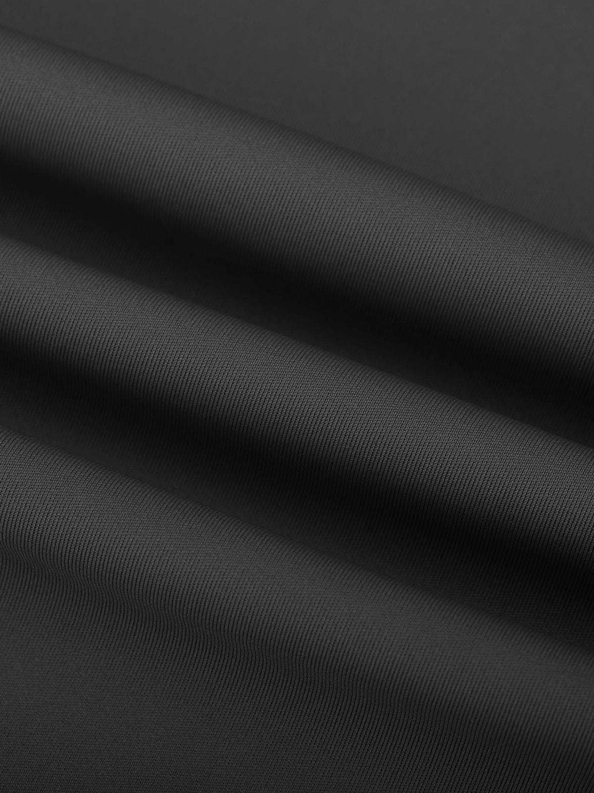 Detail shot of the opaque, second-skin Standard Black material on Vractive bare feel leggings