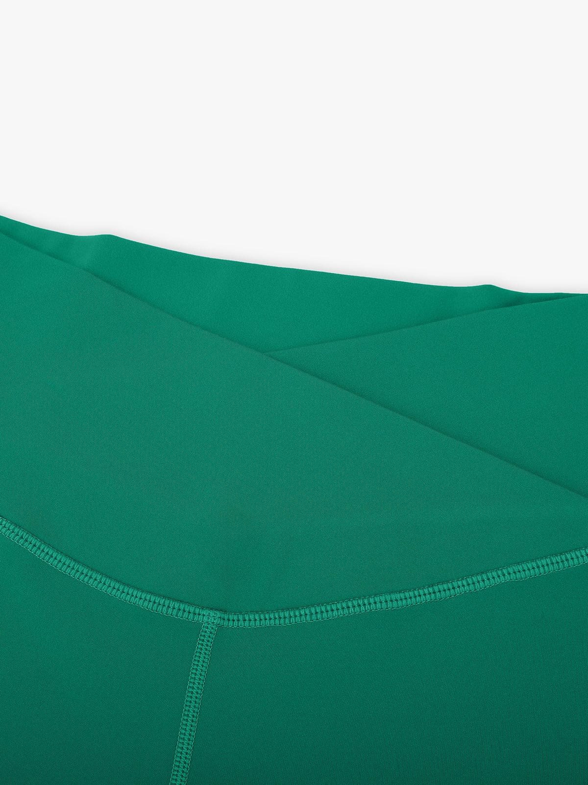 Close-up of durable stretch stitching on Light Green Vractive cross waist yoga pants
