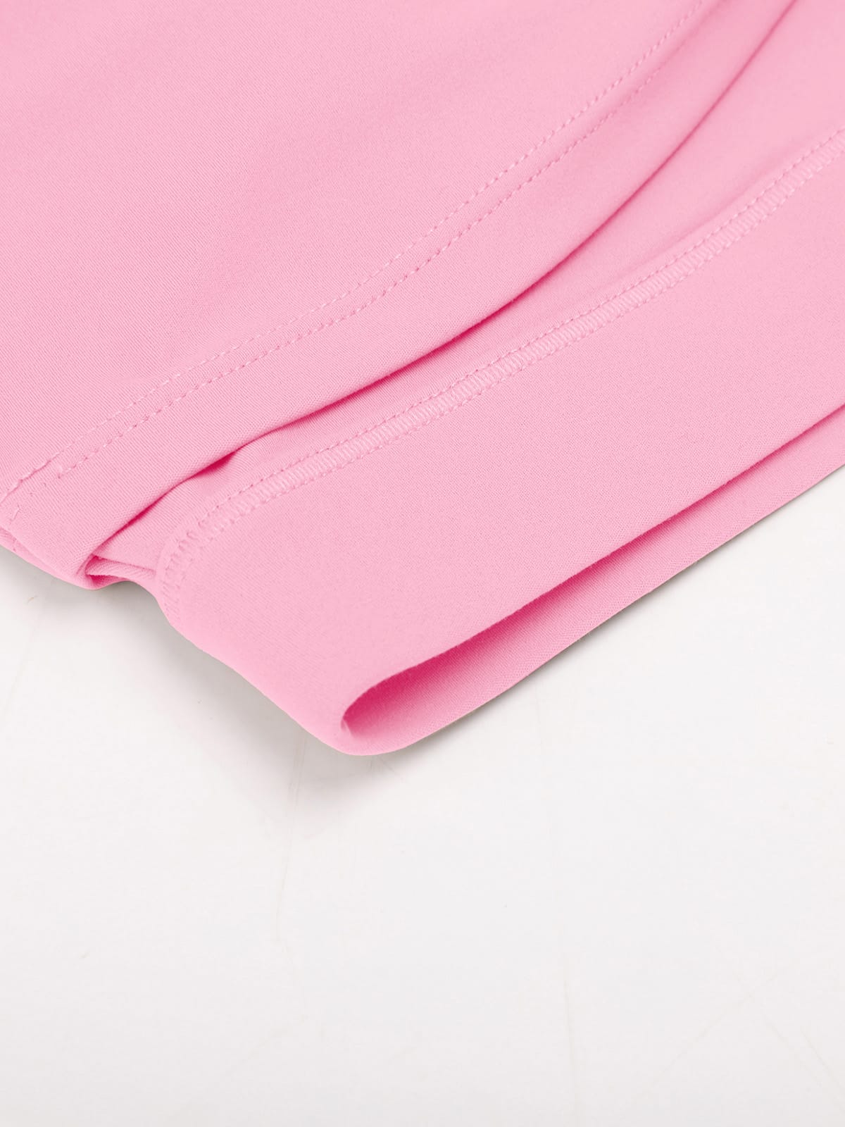 Pink yoga crop top hem stitching detail