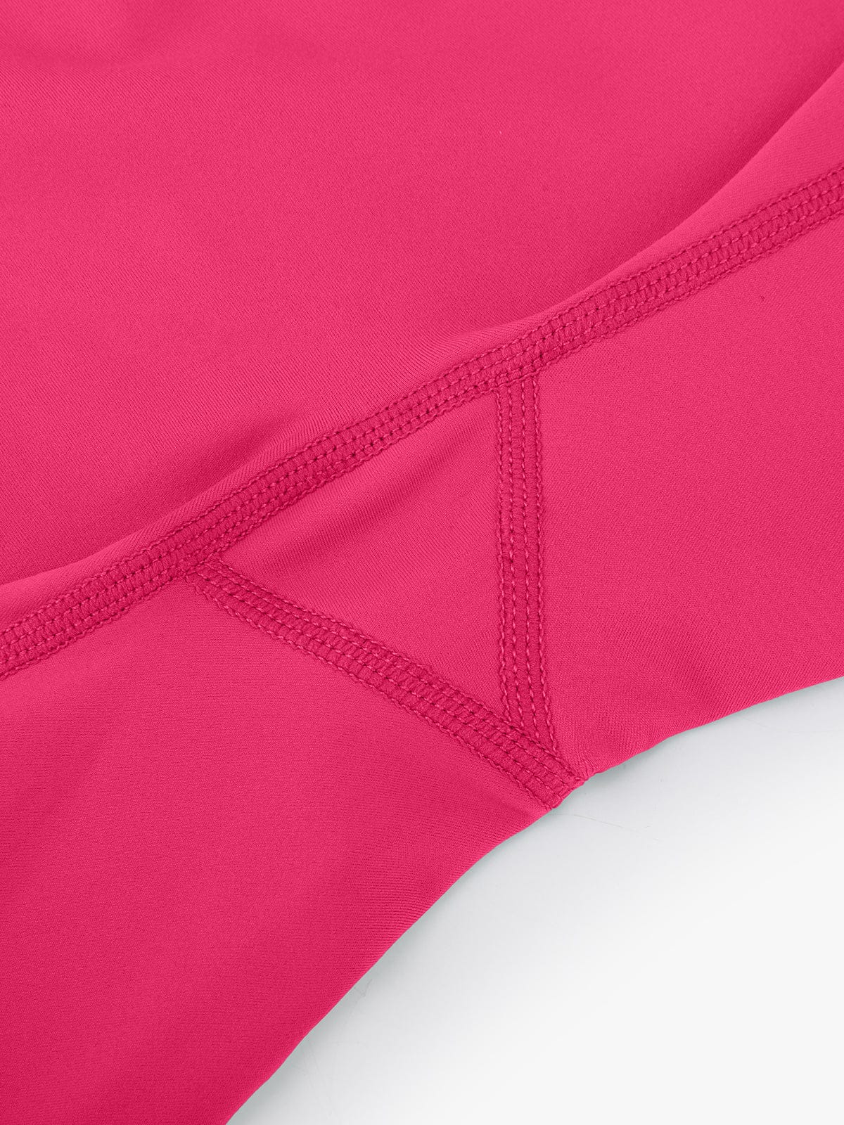 Detail shot highlighting the reinforced seams and durable stitching on Raspberry Red Vractive gym shorts