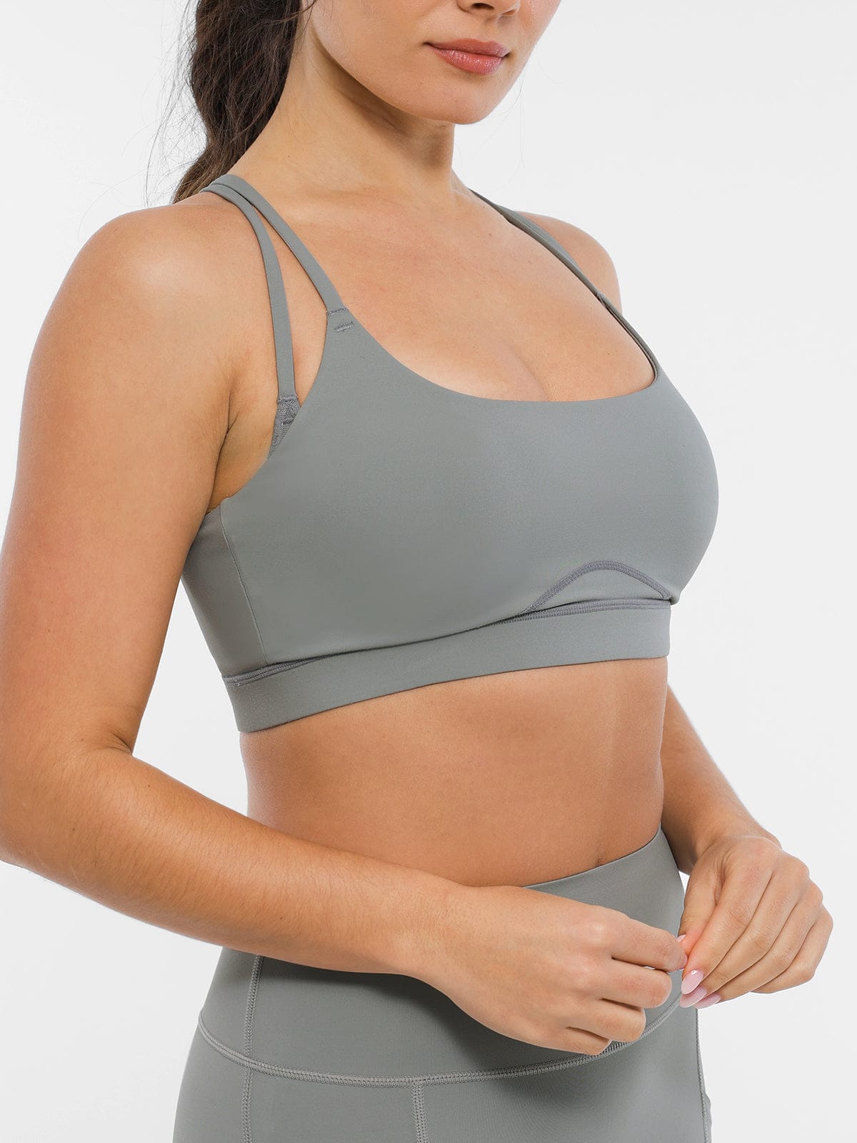 Model wearing Vractive lightweight medium support sports bra in Neutral Gray side view