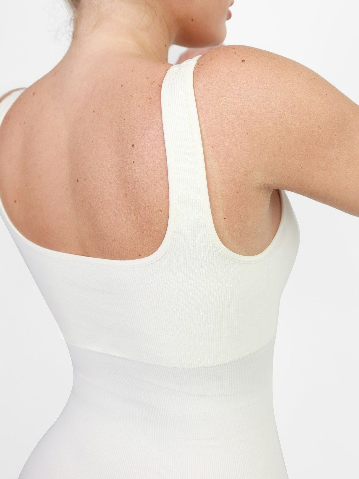 Back strap detail of white Vractive seamless one piece sport jumpsuit, seamless activewear
